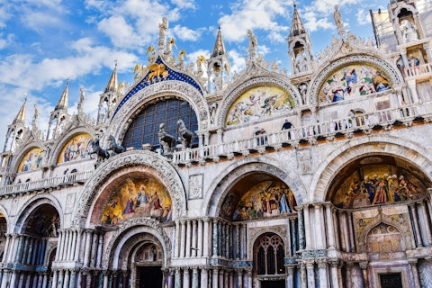 Marvel at the Byzantine mosaics and golden domes of St Mark's Basilica, a seven-minute walk