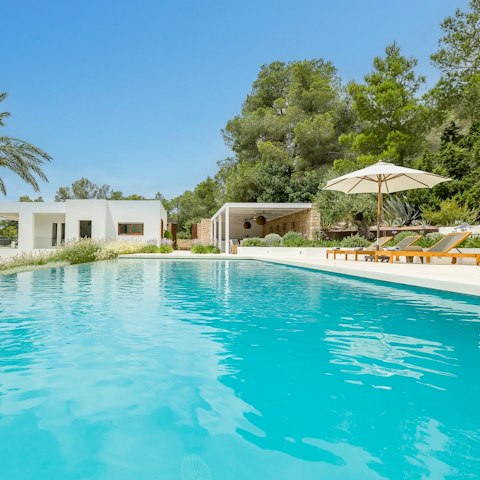 Relax by the pool with a drink in hand