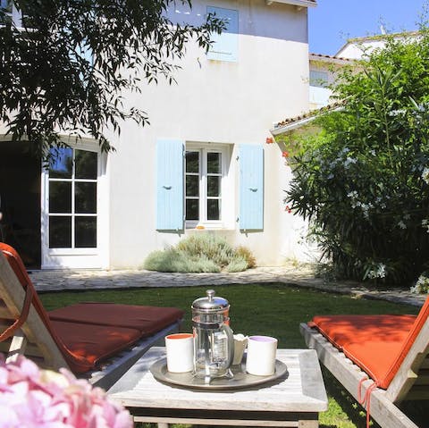 Enjoy a morning cup of coffee in the lovingly cultivated garden