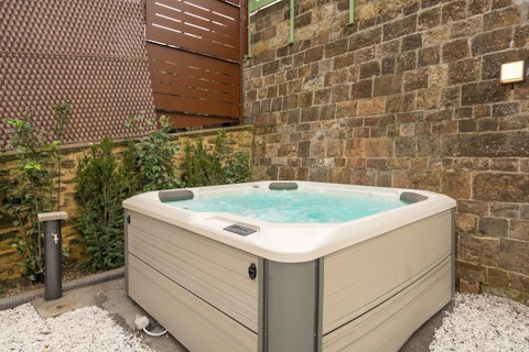 Relax and unwind in the shared hot tub