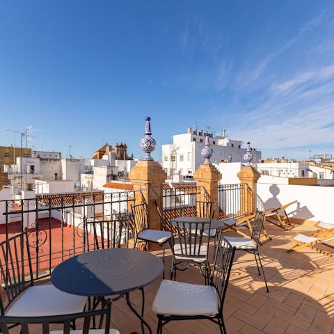 Admire the views over Seville from the shared rooftop terrace