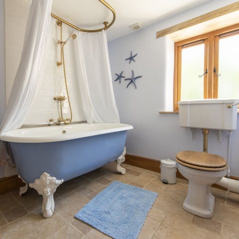 Have a long soak in the cornflower blue roll top bath