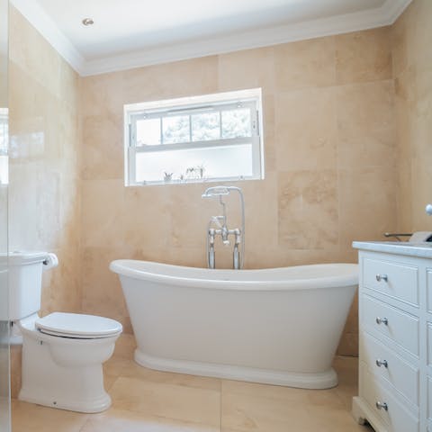 Close your eyes and sink back into warm water in the freestanding bathtub
