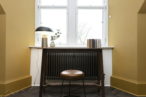 Work from home at the compact desk in the window