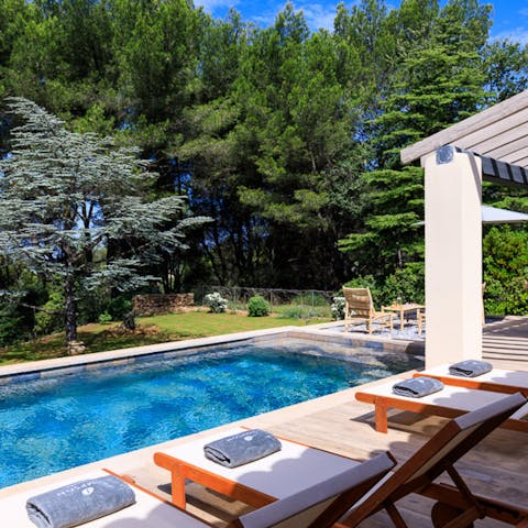 Unwind by the private heated pool