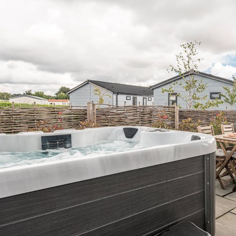 Catch the sunset while sitting back in the hot tub on the patio