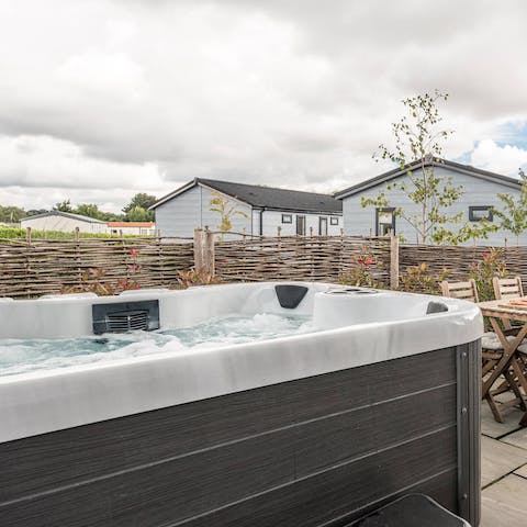 Catch the sunset while sitting back in the hot tub on the patio