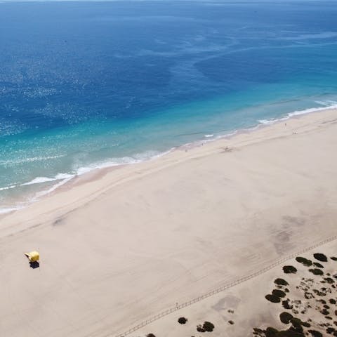 Spend a day on the white sands of Panormos Beach, just 600m away