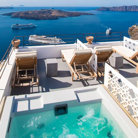 Take in the beguiling views of the caldera from the private hot tub