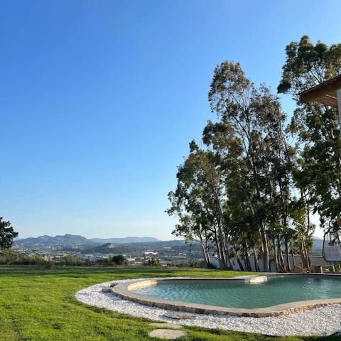 Drink in mountain views from beside the private pool