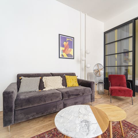 Unwind on the velvet grey sofa after a day of exploring on foot