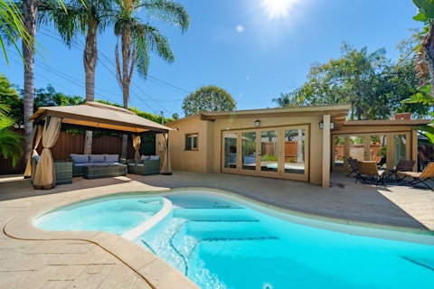 Swim under palm trees then lounge in the shaded gazebo