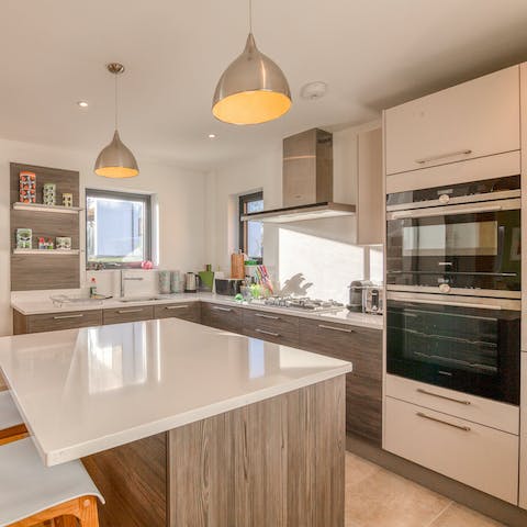 Rustle up a delicious meal in the sleek, well-equipped kitchen