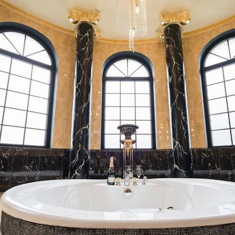 Sip something bubbly as you unwind in the sunken bathtub