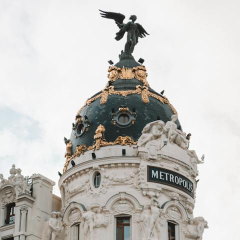 Admire the Metropolis Building on Grand Via, a five-minute walk away