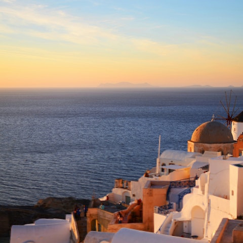 Watch the sunset over Oia's blue-roofed buildings