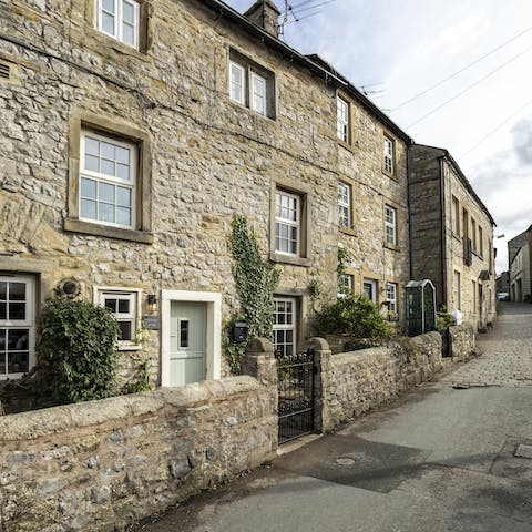 Take a seat in the small walled garden on a quaint street