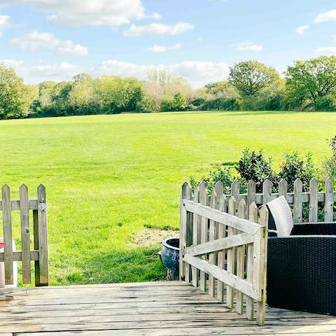 Step straight out onto a huge open field from your private decking area