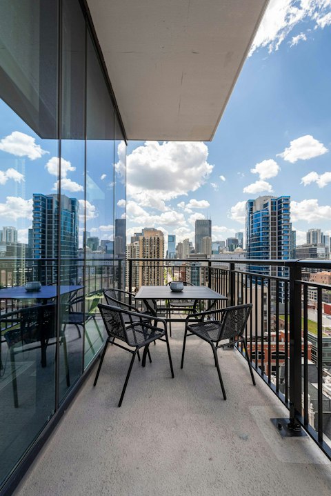Dine alfresco on the balcony with the city spread before you