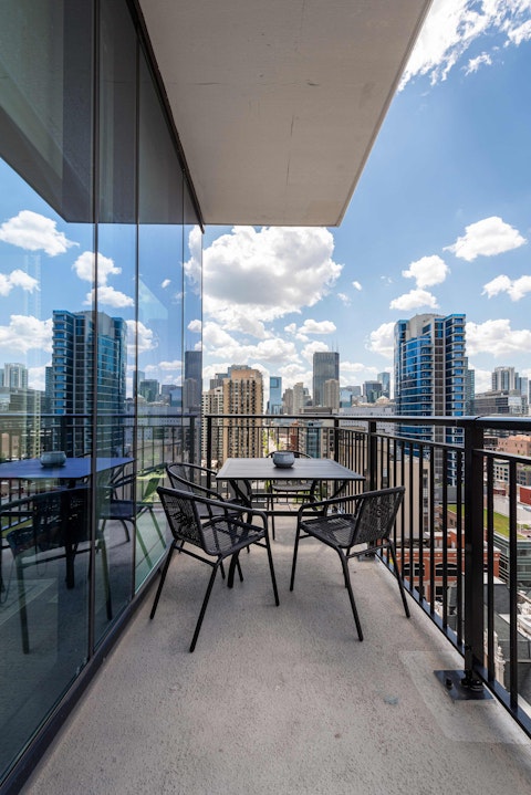 Dine alfresco on the balcony with the city spread before you