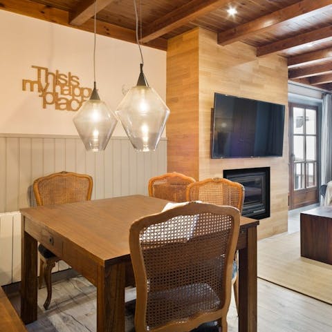 Gather around the dining table for relaxed dinners at home, with the low hanging lighting setting the ambience