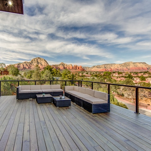 Take in the views from the balcony, drink in hand