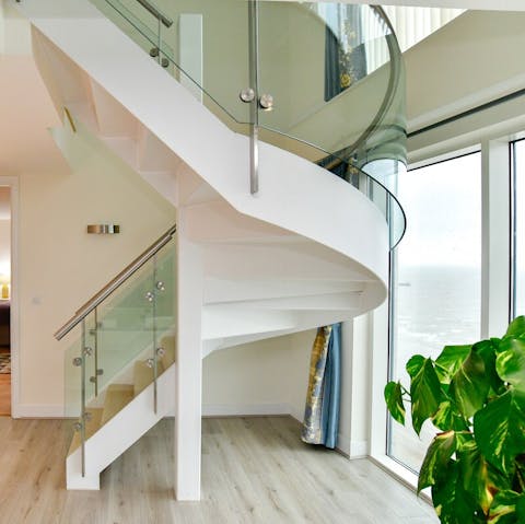 Enjoy the ample space of this luxurious penthouse, benefitting from a statement staircase