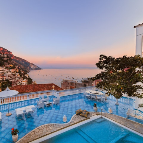 Swim above Positano as the sun melts into the sea