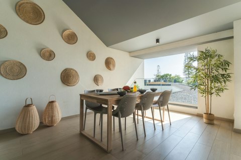 Enjoy long dinners on the shaded terrace, with glimpses of the sea beyond