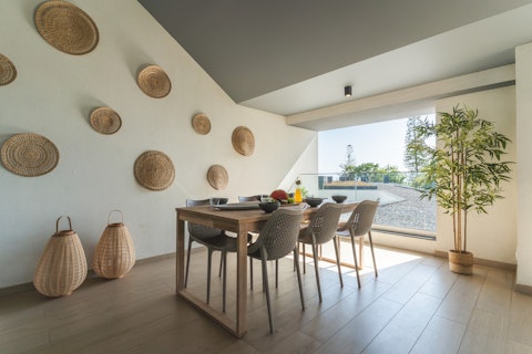 Enjoy long dinners on the shaded terrace, with glimpses of the sea beyond
