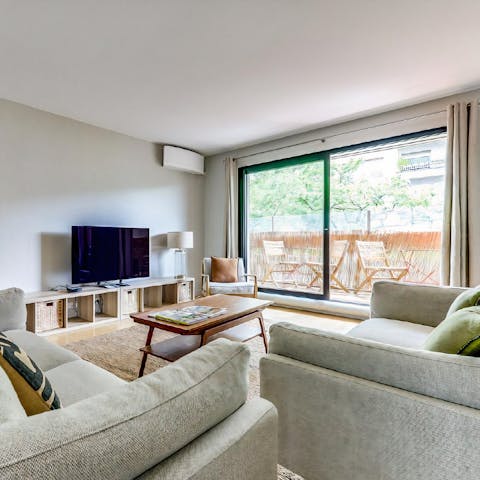 Bask in the natural light from floor-to-ceiling windows in the living room