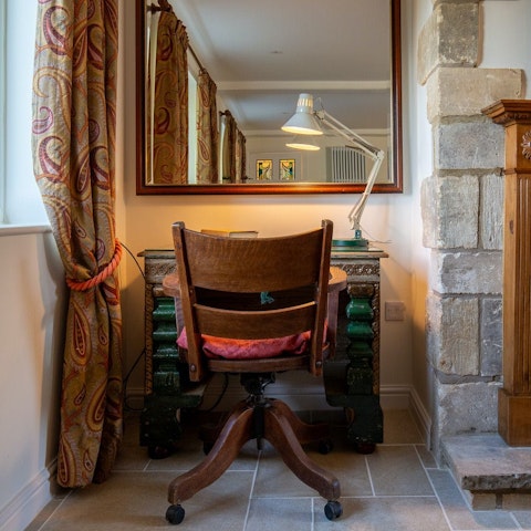 Work from home by the  fire at the antique desk in the living area