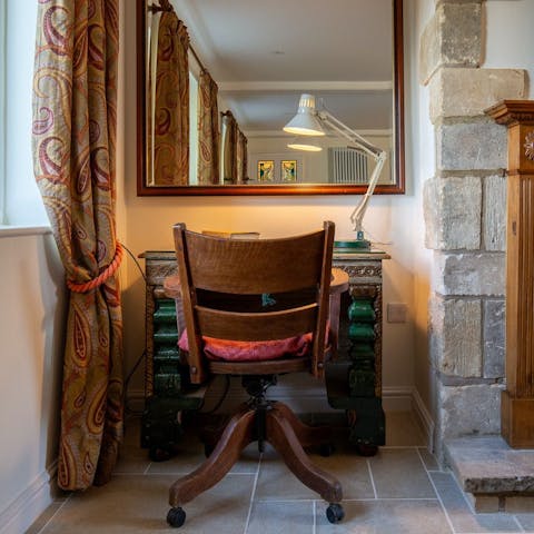 Work from home by the fire at the antique desk in the living area