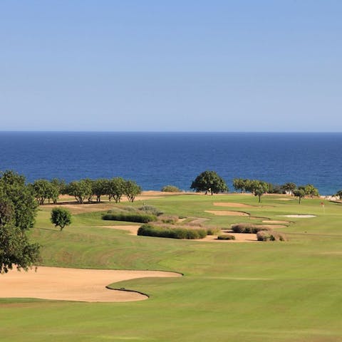 Practice your putting on the lush greens of Dom Pedro Golf Course, just an eleven-minute walk away