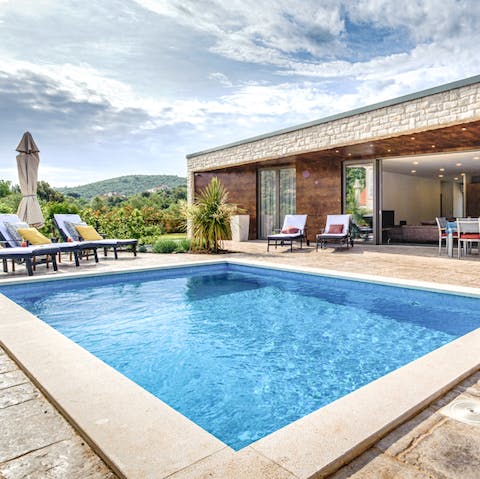 Swim against the backdrop of verdant hills