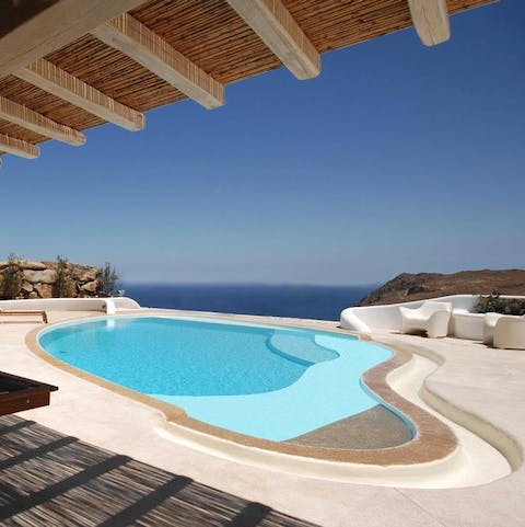 Stare out at the sea from the cool of the free-form swimming pool