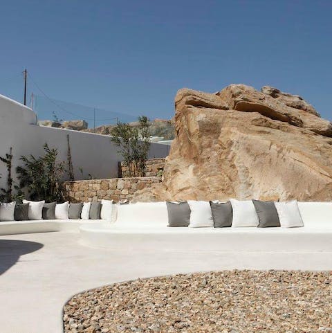 Pick a sunny spot on the curvacious stone seats around the terrace