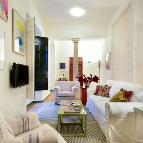 Relax in the inviting living room with a glass of Spanish wine after a day of exploring the city