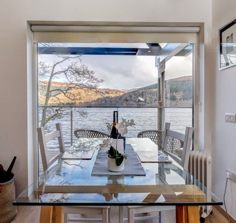Dine at the glass table with Loch Tay stretching before you