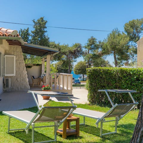 Enjoy glimpses of the sea as you sunbathe in the garden