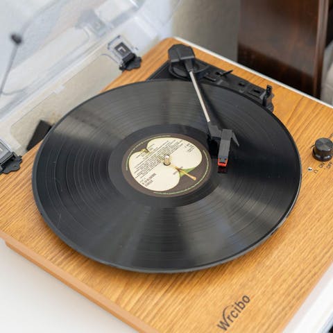 Put on an old vinyl record on the turntable