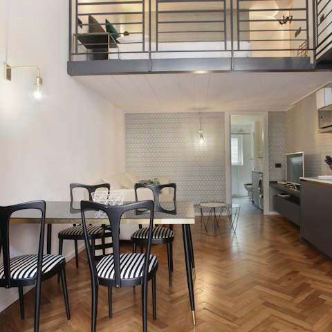 Enjoy a glass of Prosecco at the dining table in the double-height living space