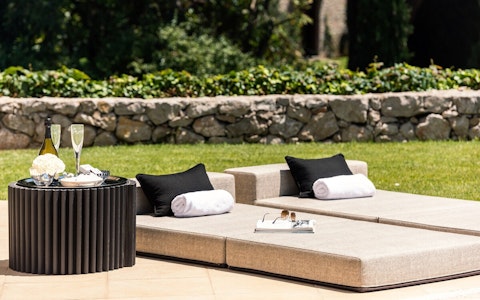 Stretch out on padded loungers with chilled champagne beside you