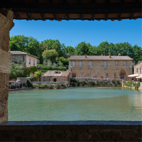 Take a therapeutic dip in the hot springs of Bagno Vignoni, a fifteen-minute drive away
