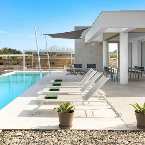 Stretch out on a sunbed or cool off in the pool