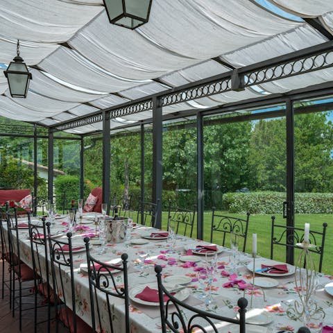 Dine in the glass verandah, with garden views