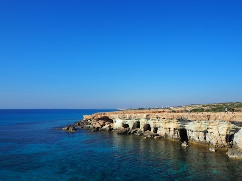 Explore Cape Greco's dramatic sea caves and crystal-clear waters