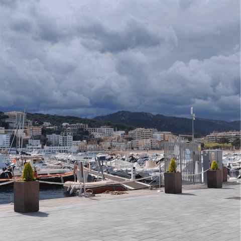 Stroll around the marina at Sant Feliu de Guixols, en route to the town's sandy beach