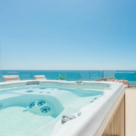 Unwind in your private Jacuzzi and take in the sea views