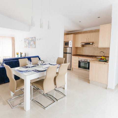 Cook up tasty tapas dishes in the fully-equipped kitchen and eat around the dining set
